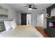 Comfortable bedroom featuring hardwood floors, a fireplace, barn door, and stylish decor at 7110 Northgreen Dr, Atlanta, GA 30328
