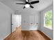 Bedroom featuring hardwood floors, a window, closet and a ceiling fan at 7110 Northgreen Dr, Atlanta, GA 30328