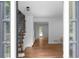 Bright entryway featuring hardwood floors, staircase with iron railings, and views of the front yard at 7110 Northgreen Dr, Atlanta, GA 30328