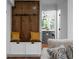 Mudroom boasts a wooden storage bench and hooks, leading to the kitchen at 7110 Northgreen Dr, Atlanta, GA 30328