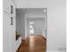 Hallway featuring hardwood floors, white walls, and built-in bench storage at 7110 Northgreen Dr, Atlanta, GA 30328
