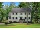 Charming two-story home with symmetrical windows, gray shutters, and a well-maintained front yard and garden at 7110 Northgreen Dr, Atlanta, GA 30328