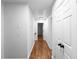 Bright hallway featuring hardwood floors, white trim, and neutral walls at 7110 Northgreen Dr, Atlanta, GA 30328