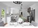 Open kitchen with white cabinets, stainless appliances, and island with seating at 7110 Northgreen Dr, Atlanta, GA 30328