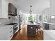 Spacious kitchen with white cabinets, a dark island, stainless steel appliances, and a breakfast bar at 7110 Northgreen Dr, Atlanta, GA 30328