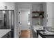 Kitchen features stainless steel refrigerator, shelving, and hardwood floors at 7110 Northgreen Dr, Atlanta, GA 30328