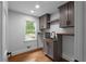 Laundry room features cabinets, shelving, sink, and hardwood floors at 7110 Northgreen Dr, Atlanta, GA 30328