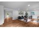Open living room featuring hardwood floors, neutral-toned furniture, recessed lighting, and stylish decor at 7110 Northgreen Dr, Atlanta, GA 30328