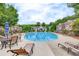 Community pool area with ample lounge seating surrounded by lush landscaping and neighborhood residences at 2336 Heritage Park Nw Cir # 11, Kennesaw, GA 30144