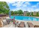 A luxurious community pool is surrounded by lounge chairs and lush greenery and is perfect for relaxation at 2336 Heritage Park Nw Cir # 11, Kennesaw, GA 30144