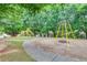 Neighborhood playground with swings and a slide, surrounded by mature trees at 2336 Heritage Park Nw Cir # 11, Kennesaw, GA 30144