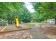 View of neighborhood playground featuring a slide, swings, and walking path at 2336 Heritage Park Nw Cir # 11, Kennesaw, GA 30144