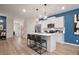 Modern kitchen with stainless steel appliances, island seating, and hardwood floors at 33 Cedar Dr, Fairburn, GA 30213