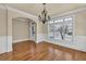 Classic dining room with hardwood floors, large windows, an arched doorway, and beautiful trim at 3810 Baverton Dr, Suwanee, GA 30024