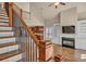 Open floor plan with staircase leading to a living room featuring a fireplace and built-in shelving at 3810 Baverton Dr, Suwanee, GA 30024
