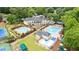 Aerial view of the clubhouse featuring a pool, tennis courts, and a well-maintained lawn at 130 Silver Mist Cir, Alpharetta, GA 30022