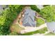 Aerial view of home's roof, deck with patio seating, and landscaped backyard at 130 Silver Mist Cir, Alpharetta, GA 30022