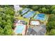 Aerial view showcasing community amenities: pools, tennis courts, and picturesque surroundings by the lake at 130 Silver Mist Cir, Alpharetta, GA 30022
