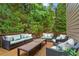Wooden back deck with dark wicker couches and chairs for outdoor living at 130 Silver Mist Cir, Alpharetta, GA 30022