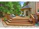 Large wooden back deck with stairs, seating areas and lush tree surround at 130 Silver Mist Cir, Alpharetta, GA 30022