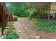 Backyard landscaped with a stone path and steps surrounded by trees and plants, creating a natural pathway at 130 Silver Mist Cir, Alpharetta, GA 30022