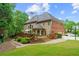 Expansive backyard featuring a wooden deck, lush greenery, and well-manicured lawn perfect for outdoor activities at 130 Silver Mist Cir, Alpharetta, GA 30022