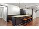 Basement bar area with granite countertops, dark wood cabinets, and stool seating at 130 Silver Mist Cir, Alpharetta, GA 30022