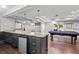 The finished basement boasts a wet bar with granite countertops, a pool table, and recessed lighting at 130 Silver Mist Cir, Alpharetta, GA 30022