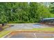Community basketball court surrounded by mature trees with shade for players and benches for spectators at 130 Silver Mist Cir, Alpharetta, GA 30022