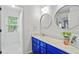 Bright bathroom features a vanity with double mirrors, and a tiled walk in shower at 130 Silver Mist Cir, Alpharetta, GA 30022