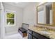 Bathroom with granite vanity and window view, and walk in shower with shower curtain at 130 Silver Mist Cir, Alpharetta, GA 30022