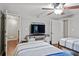 This bedroom features two beds, a ceiling fan, and a TV on a white farmhouse console table at 130 Silver Mist Cir, Alpharetta, GA 30022