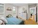 Bright bedroom with plantation shutters, neutral paint, modern dresser and decor on shelves at 130 Silver Mist Cir, Alpharetta, GA 30022