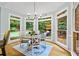 Sunny breakfast nook and dining area overlooking private deck and backyard at 130 Silver Mist Cir, Alpharetta, GA 30022
