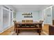 Traditional dining room with wainscoting, plantation shutters, wood table, and wicker chairs at 130 Silver Mist Cir, Alpharetta, GA 30022