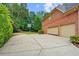 Wide driveway leading to a two-car garage and basketball hoop, offering space for parking and recreation at 130 Silver Mist Cir, Alpharetta, GA 30022