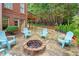 Inviting backyard featuring a stone fire pit surrounded by Adirondack chairs, perfect for outdoor relaxation at 130 Silver Mist Cir, Alpharetta, GA 30022