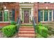 Close up of the brick home's entryway with beautiful door and landscaping at 130 Silver Mist Cir, Alpharetta, GA 30022
