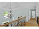 Upper hallway with decorative lighting, iron railing, and views through an arched window at 130 Silver Mist Cir, Alpharetta, GA 30022