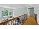Hallway overlooking living room and stone fireplace at 130 Silver Mist Cir, Alpharetta, GA 30022
