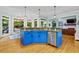 Kitchen island with granite countertops and a breakfast bar overlooks backyard at 130 Silver Mist Cir, Alpharetta, GA 30022