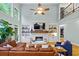 Open concept living room with a stone fireplace, built-in shelving, and hardwood floors at 130 Silver Mist Cir, Alpharetta, GA 30022