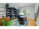 Office with a large window, built-in bookshelves, and hardwood floors at 130 Silver Mist Cir, Alpharetta, GA 30022
