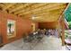 Covered patio with a concrete floor, outdoor dining set, brick walls, and natural wood ceiling for outdoor entertaining at 130 Silver Mist Cir, Alpharetta, GA 30022