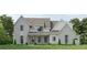 Charming two-story home with gray brick and siding, a covered porch, and a well-manicured lawn at 133 Daxton Dr, Canton, GA 30115