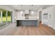 Bright, open kitchen with a large island, stainless steel appliances, and sliding glass doors to the backyard at 133 Daxton Dr, Canton, GA 30115