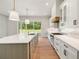Bright kitchen with an island, stainless steel appliances, and white cabinets providing a gourmet cooking experience at 133 Daxton Dr, Canton, GA 30115