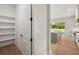 Walk-in pantry with open shelving conveniently located adjacent to a modern kitchen featuring an island at 133 Daxton Dr, Canton, GA 30115