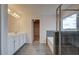 Bright primary bathroom with double sinks, separate tub, and tiled glass shower at 247 Arnewood Cir, Mcdonough, GA 30253