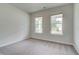 Bright bedroom with carpet, two windows and neutral walls at 247 Arnewood Cir, Mcdonough, GA 30253